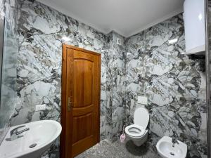 a bathroom with a toilet and a sink at ABX seaview Apartment in Golem