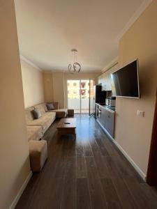 a living room with a couch and a tv at ABX seaview Apartment in Golem