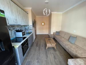 a living room with a couch and a table at ABX seaview Apartment in Golem