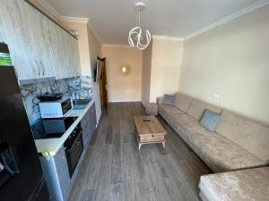 a living room with a couch and a table at ABX seaview Apartment in Golem +2 photos