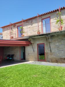 a stone building with a lawn in front of it at Alijó Douro House in Alijó