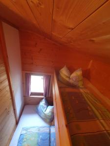 an empty room with two bunk beds in a cabin at Weiherhütte Ried in Ried im Oberinntal