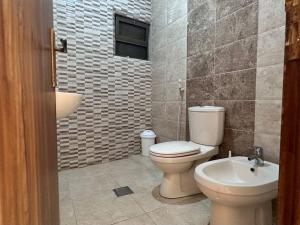 a bathroom with a toilet and a sink at 4 Bedroom Flat in Madaba with AC in Madaba