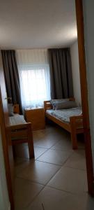 a small room with two beds and a window at Green House Source Vrilo in Tomislavgrad