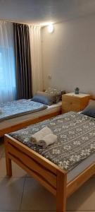 a bedroom with two beds with towels on them at Green House Izvor Vrilo in Tomislavgrad