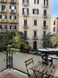 a balcony with a bench and a building at Dante Suites in Palermo