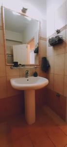 a bathroom with a white sink and a mirror at Katerinas Apartments in Neos Marmaras