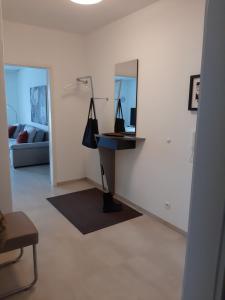 a living room with a desk and a mirror at 2 Zimmer Ferienwohnung mit Seeblick in Überlingen in Überlingen