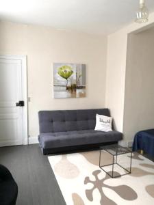 a living room with a couch and a rug at Appartement de 2 chambres avec wifi a Givet in Givet