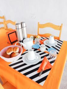 a table with a black and white striped table cloth at Pousada Cantinho de Preta in Seladinha
