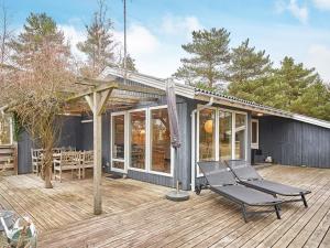 a deck with two lounge chairs on a house at Holiday home Aakirkeby XLIV in Vester Sømarken