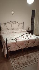 a bedroom with a large bed with a rug at Casa Sofia: comodi e tranquilli in Maruggio