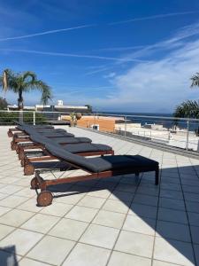 a row of benches sitting on top of a roof at B&B Le Sette Vele Da Riccardo in Santa Marina Salina
