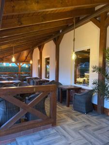 a dining room with wooden tables and chairs at Hotel Rosengarten in Frankfurt Oder