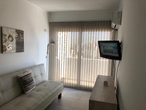 a living room with a couch and a television at La Plata Bs As , departamento vista panoramica a metros de todo in La Plata