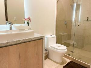 a bathroom with a toilet and a sink and a shower at 2BR Modern 5th Avenue Apt -Distrito Corazon D1 in Playa del Carmen +16 photos