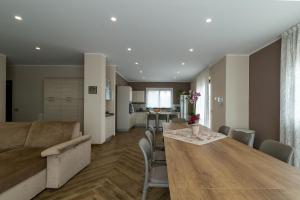 a living room and kitchen with a table and a couch at Casa Il Geranio in Piedimonte Etneo +72 photos