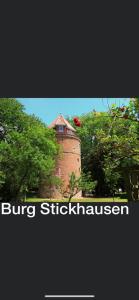 a brick tower in the middle of some trees at Ferienwohnung Margrit in Detern