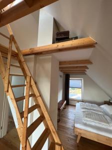 a room with a bunk bed and a ladder at Ferienhaus "Haus am See" in Prenzlau