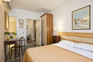 een slaapkamer met een bed, een bureau en een tafel bij B&B Le Sibille in Rome