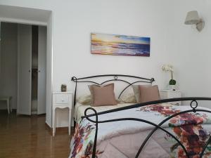 1 dormitorio con 1 cama con una foto en la pared en Guest house al mare en Civitavecchia