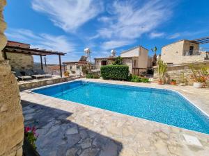 a swimming pool in the backyard of a house at Poseidon's Pool Paradise in Skarinou