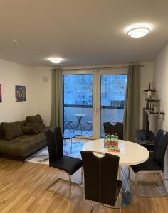 a living room with a table and chairs and a couch at Amazing City Center Apartment in Vienna