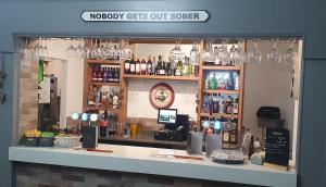 a bar with a counter with wine glasses at The Whitehouse Peterlee in Peterlee