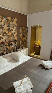 a bedroom with a large bed and a mirror at B&B LE CUSPIDI in Ginosa