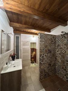 a bathroom with a white sink and a mirror at B&B LE CUSPIDI in Ginosa