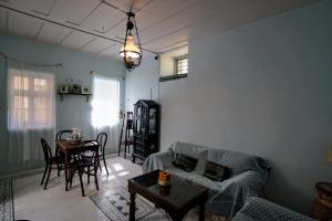 a living room with a couch and a table at Say Yes Symi House in Symi