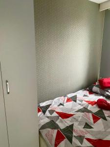 a bed with a quilt on it in a bedroom at Apartament Poznańska 24 in Bydgoszcz