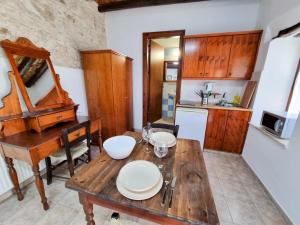a kitchen with a wooden table and a dining room at Poseidon's Pool Paradise in Skarinou