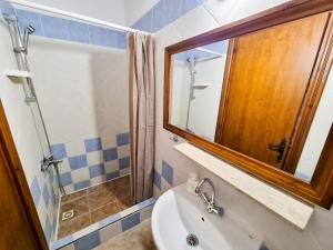 a bathroom with a sink and a mirror at Poseidon's Pool Paradise in Skarinou