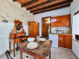 a kitchen and dining room with a wooden table at Poseidon's Pool Paradise in Skarinou