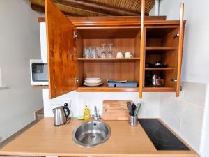 a kitchen with a sink and a counter top at Poseidon's Pool Paradise in Skarinou