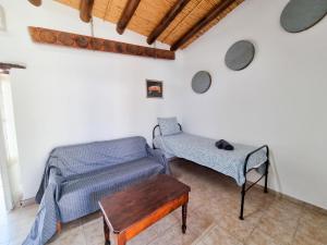 a living room with a couch and a table at Poseidon's Pool Paradise in Skarinou