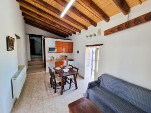 a living room with a table and a couch at Poseidon's Pool Paradise in Skarinou
