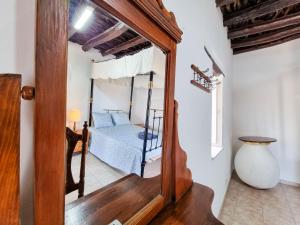 a bedroom with a bed and a mirror in a room at Poseidon's Pool Paradise in Skarinou