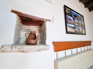 a tea kettle sitting on a fireplace in a room at Poseidon's Pool Paradise in Skarinou