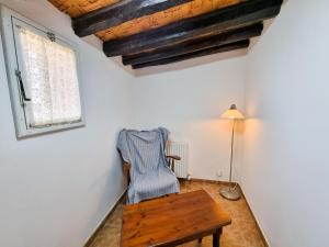 a room with a chair and a table and a window at Poseidon's Pool Paradise in Skarinou