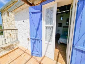 a room with a blue door and a bedroom at Poseidon's Pool Paradise in Skarinou