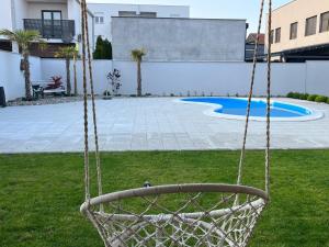un'altalena in un cortile con piscina di Infinity a Novi Sad
