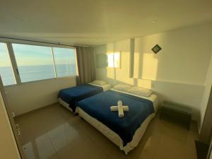 a room with a bed with a cross on it at Ocean View Apartments IH RENTALS in Cartagena de Indias