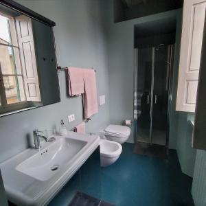 a bathroom with a sink and a toilet and a shower at IL DECUMANO CHARME APARTMENTS in Arezzo