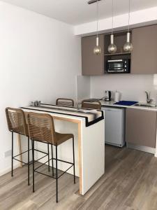 a kitchen with a counter and chairs in a room at Godoy House in Buenos Aires