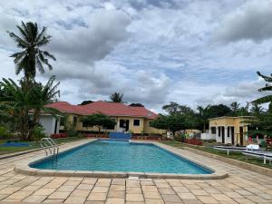a swimming pool in front of a house at Christina Residence in Dar es Salaam