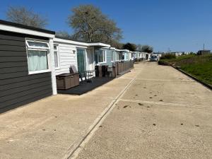 una fila di case mobili parcheggiate accanto a un marciapiede di 2 Bedroom Chalet, SB10, Sandown, Isle of Wight, Dog Friendly, Free WiFi a Sandown