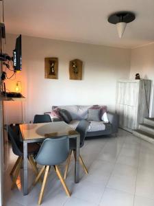 a living room with a table and a couch at La Finestra sulla Torre in Stintino