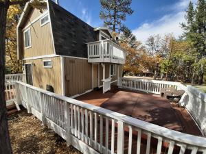a house with a balcony and a deck at Cabin on the Corner in Big Bear Lake